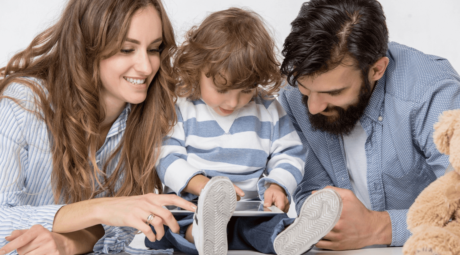 smiling-family-sitting-together-in-studio